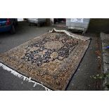 A Persian carpet, having central floral medallion; central floral field decorated with a pair of