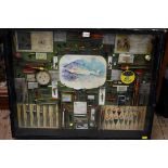 Angling: a framed display of fishing items, 63.5 x 79.5cm.