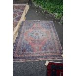 A Persian rug, having central medallion; central field decorated with urns and animal motifs with