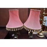 A pair of cast and pierced brass table lamps.