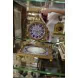 A brass and porcelain mounted timepiece, probably for the Turkish market, 18cm high.