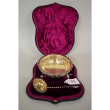 A cased Victorian silver gilt embossed sugar bowl and sifter, by William Hutton & Sons, London 1891,