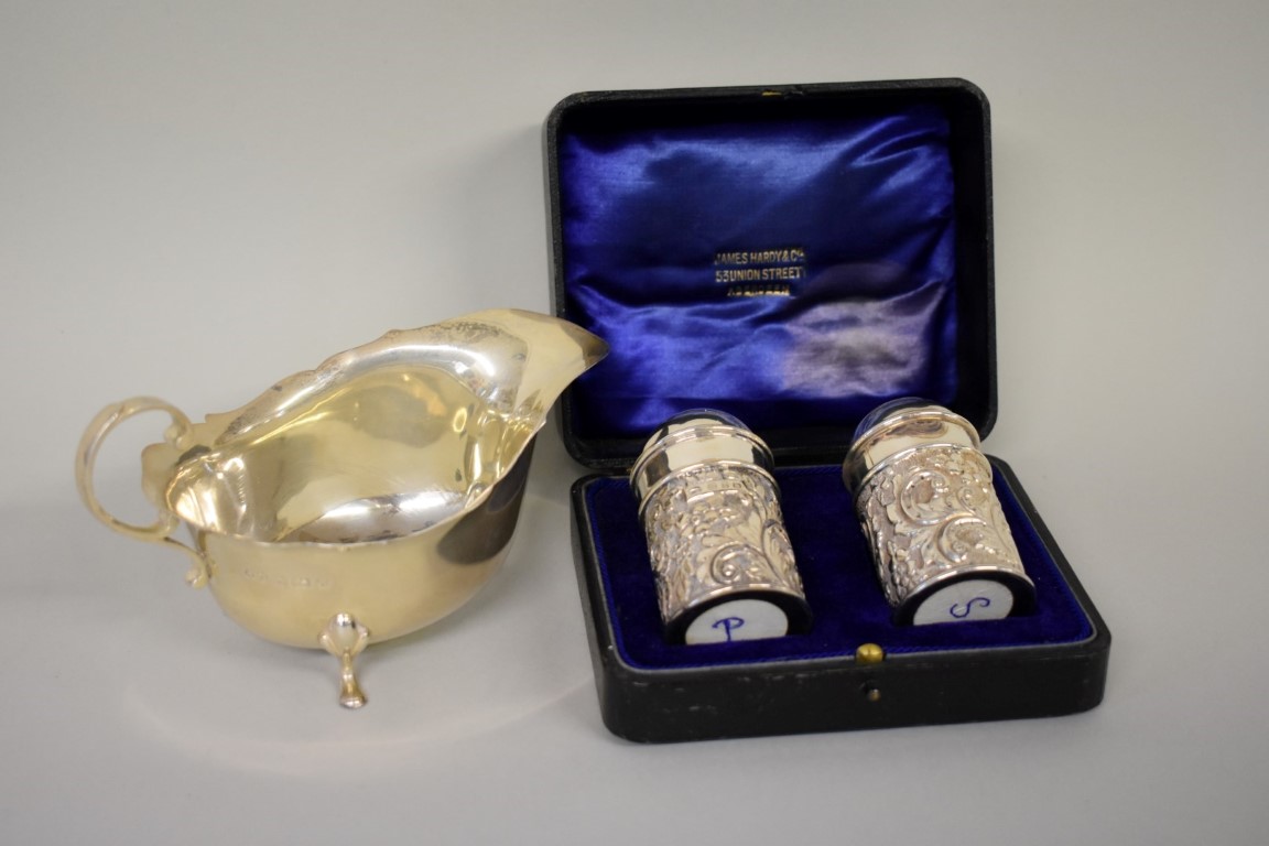 A cased Victorian embossed silver cruet set, by C T Burrows & Sons, Birmingham 1899; together with a