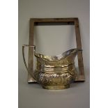 A silver embossed milk jug, by Thomas Bradbury & Sons, Sheffield 1901, 9.5cm high, 175g; together