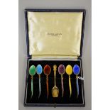 A cased set of six silver gilt and enamel coffee spoons and matching sugar scoop, by Turner &