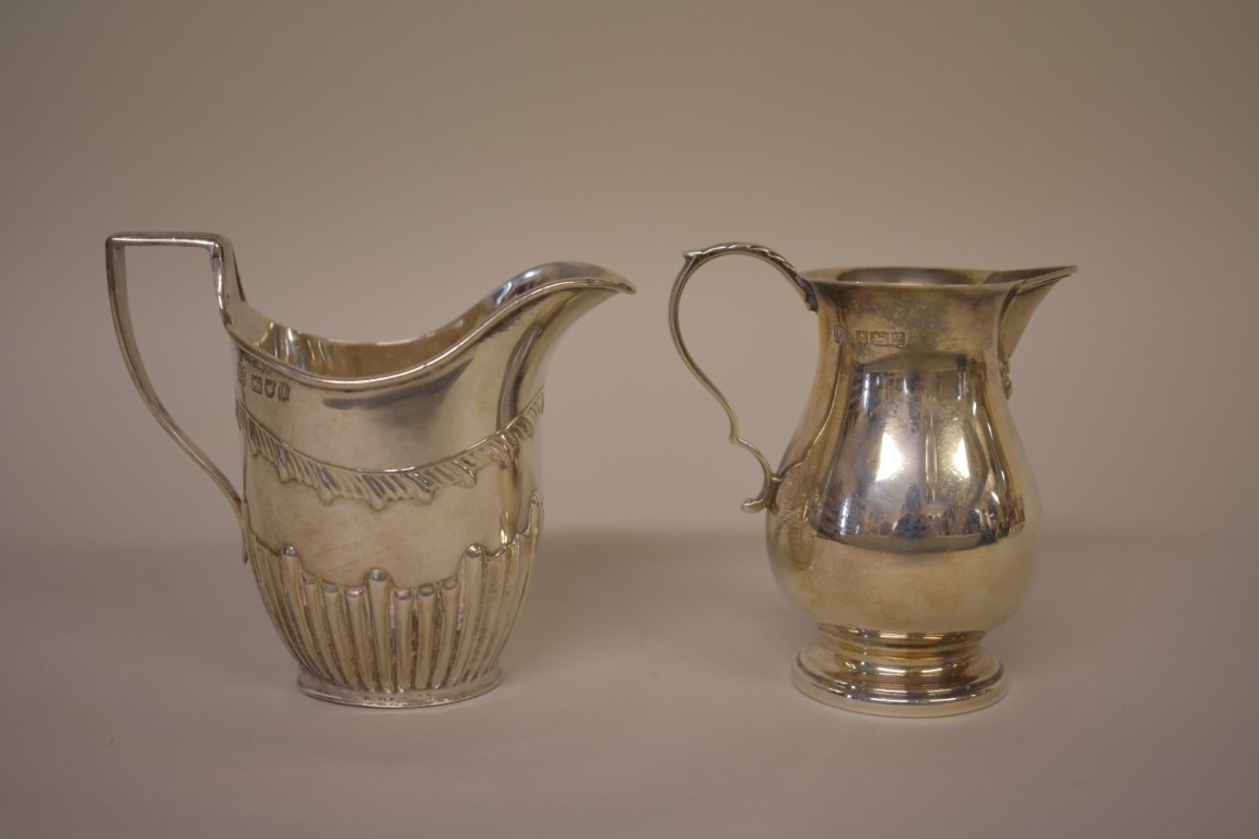 An Edwardian silver cream jug, by W & C Sissons, London 1906, 9cm; together with another modern