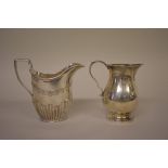 An Edwardian silver cream jug, by W & C Sissons, London 1906, 9cm; together with another modern