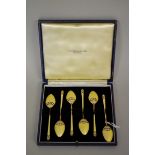 A cased set of six silver gilt and yellow enamel coffee spoons, by Turner & Simpson, Birmingham