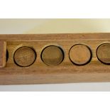 Coins: a quantity of George V & George IV 1/12 Anna copper coins, in a wooden storage box.