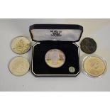 Coins: a cased QEII 1964 Bermuda crown; together with two other uncased examples; a 2002 five