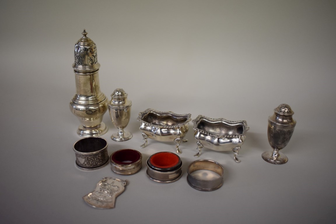 A selection of silver items, to include: a caster; condiments; and napkin holders, 362g weighable.