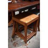 A vintage oak nest of three tables, by Heals, largest 38cm wide.