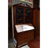 A George III mahogany and inlaid bureau bookcase, 111cm wide.