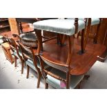 A mahogany twin pedestal extending dining table, with two leaf insertions, 249cm extended.