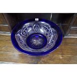 A large blue flashed cut glass circular bowl, 40.5cm diameter.