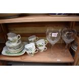 An English porcelain part tea service, painted by M Hodgetts; together with a set of wine glasses.