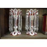 A pair of Victorian cranberry and white overlay glass lustres, 26cm high, (extensive restoration