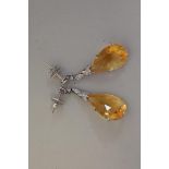 A pair of teardrop citrine and diamond white gold pendant earrings, stamped 750, 4cm, 10.5g total