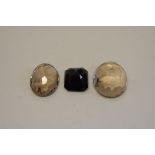 Three unmounted gem stones.