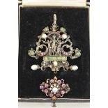 A cased 19th century Renaissance style white metal gem and baroque pearl set pendant, possibly