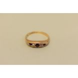 A diamond and ruby gold ring, hallmarked 18ct, 3.9g total weight.