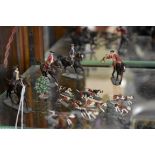 A group of small scale vintage metal figures, comprising: hunt master; three further mounted riders;