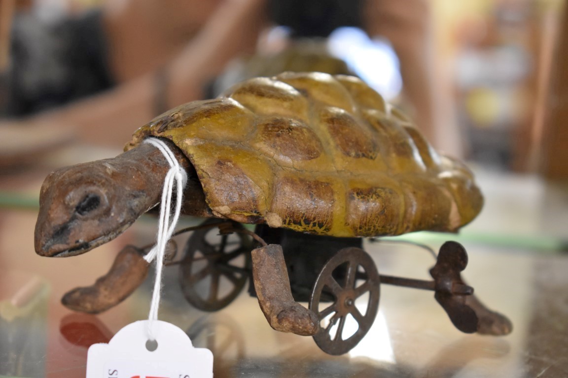 An Edwardian clockwork papier-mache turtle, 16cm nose to tail, with key.