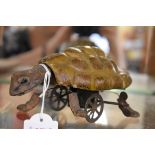 An Edwardian clockwork papier-mache turtle, 16cm nose to tail, with key.