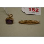 A yellow metal fob seal set carved amethyst, of galleon upon a sphere with trailing flower; together