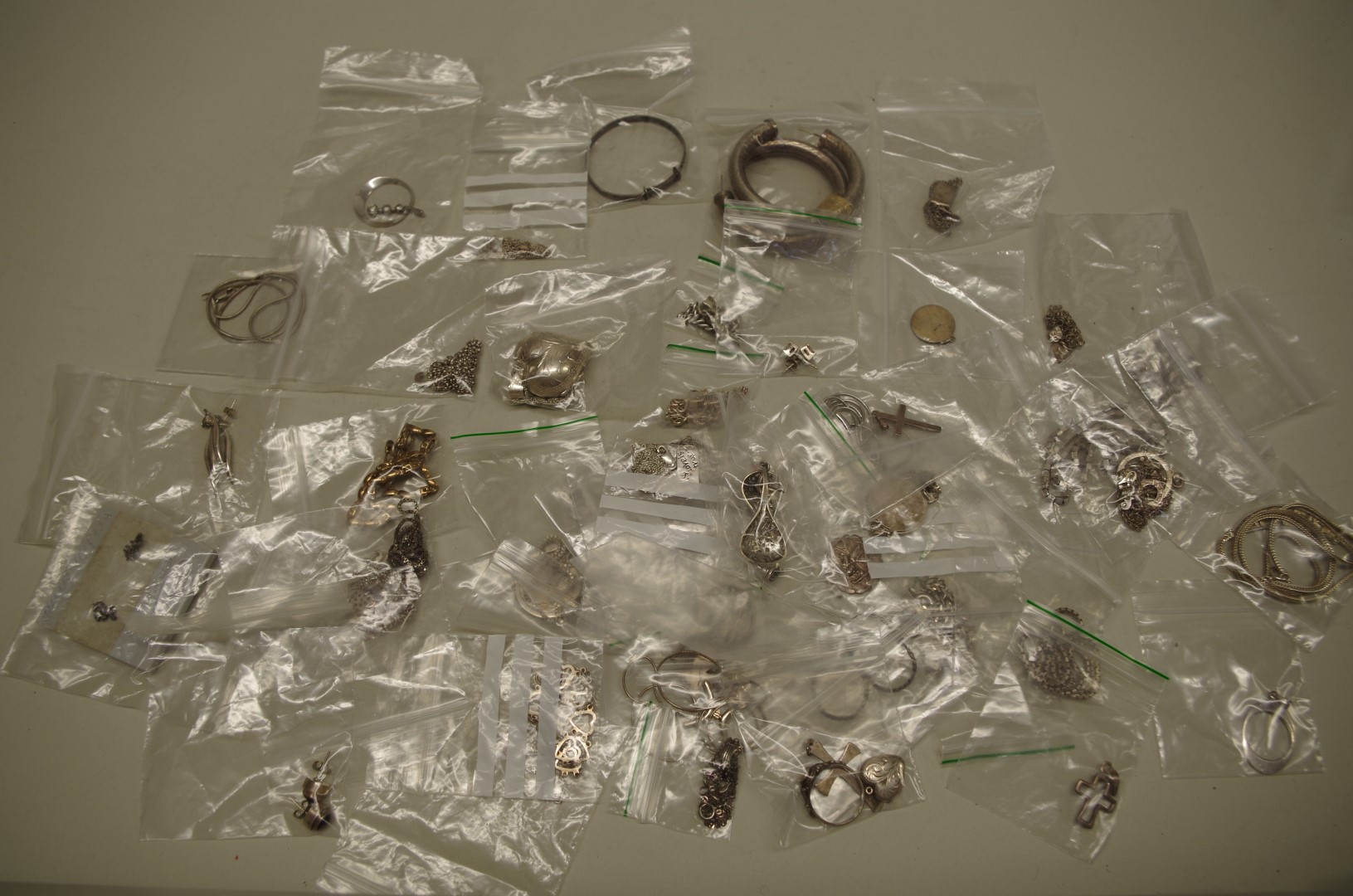 A quantity of silver and metal necklaces, bracelets, pendants etc.
