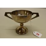 A silver twin handled trophy cup, by John Taylor & Co, Birmingham 1931, 11cm high, 195g.