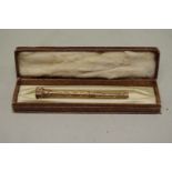 A gold chased propelling pencil, having hardstone seal finial, stamped 9ct, 12.5cm extended, 16.3g