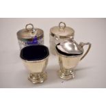 A pair of silver mounted cut glass preserve jars; together with a silver part cruet set, 171g