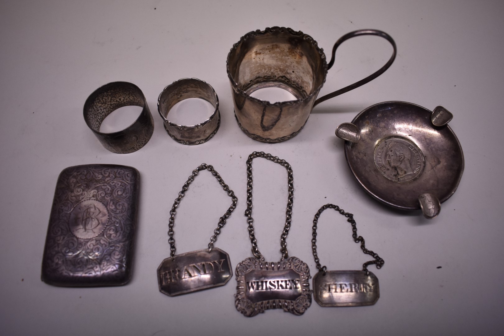 A small collection of silver items, to include three decanter labels, 241g.