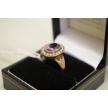 An oval amethyst and pearl unmarked yellow metal ring, 3.4g total weight.