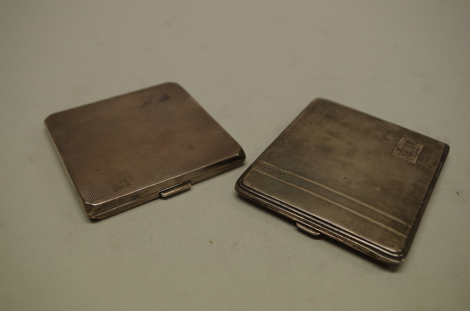 Two silver engine turned cigarette cases, 238g all in.