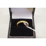 A gold wedding band, stamped 22ct, 6.4g.