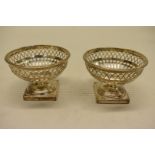 A pair of Edwardian pierced silver pedestal sweetmeat dishes, by George Nathan & Ridley Hayes,
