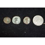 Coins: a US 1922 silver Peace dollar; together with three other coins.