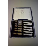 A cased set of six Harrods 'Silver Jubilee' silver and mother-of pearl butter knives, by John
