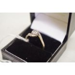 An old cut solitaire diamond ring, having diamond twist shoulders, in unmarked yellow metal,