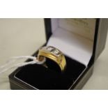 A three stone diamond yellow and white gold gentlemans ring, 0.7ct approximately, stamped 750, 15.