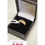 A childs three stone diamond gypsy set gold ring, hallmarked 18ct, 4g total weight.