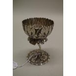 An Indian white metal lotus flower goblet, having floral decoration, 12cm.