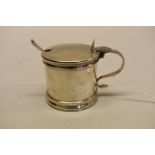 A silver mustard pot, byThomas Bradbury & Sons Ltd, Sheffield 1918, 7cm, 166g with an unmatched