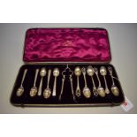 Eleven unmatched silver teaspoons and a pair of sugar nips, 132g, in associated case.