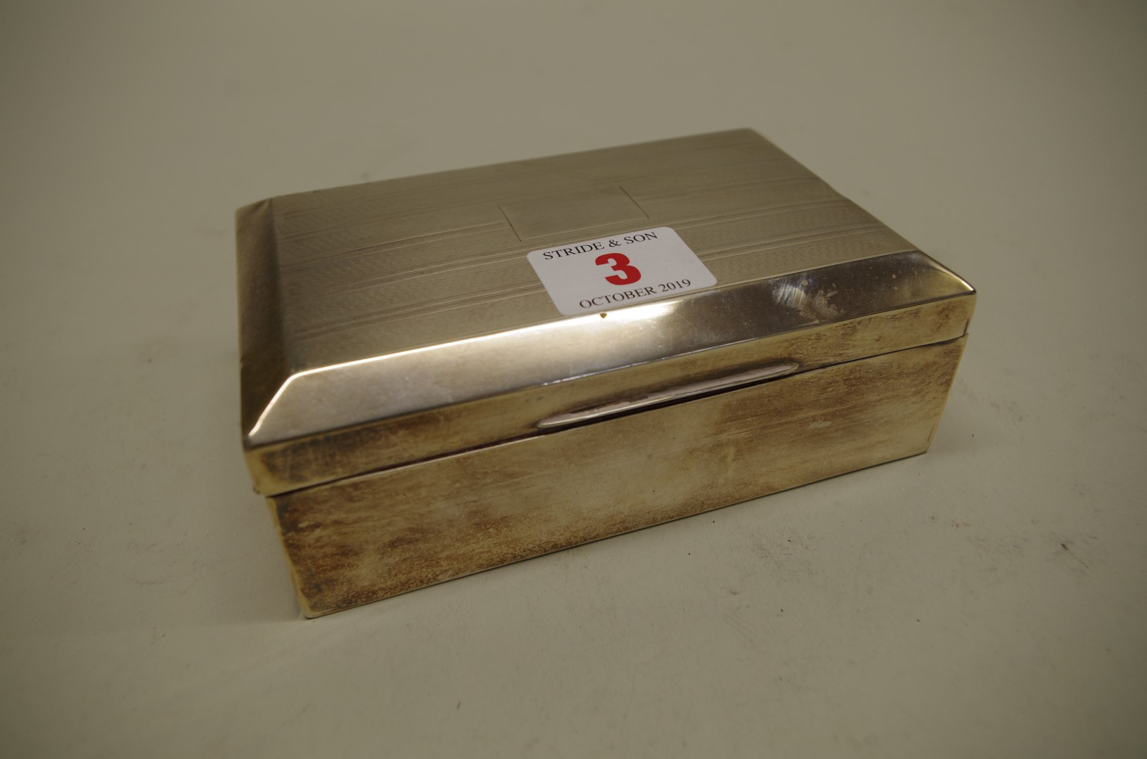 A silver cigarette box, by Barker Bros Silver Ltd, Birmingham 1932, 14 x 9cm, 464g all in.