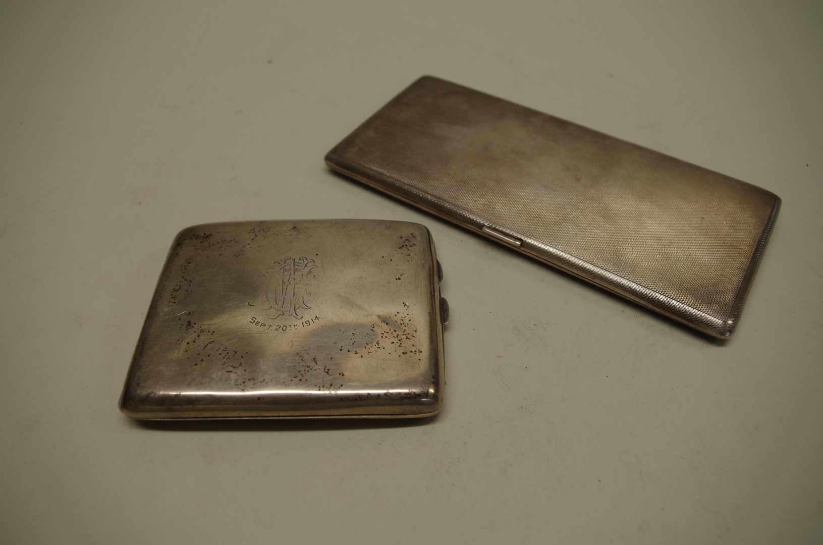 Two silver cigarette cases, 355g all in.