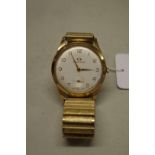 A vintage Garrard 9ct gold manual wind wristwatch, 32mm, with expanding metal bracelet and