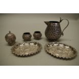 An Indian white metal cruet set; together with three other similar items. (6)